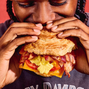 Image of man biting into sandwich