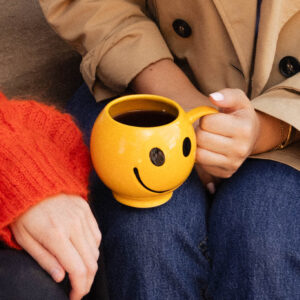 Image of a woman holding a coffee mug