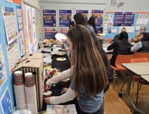 Image of woman filling coffee cup with